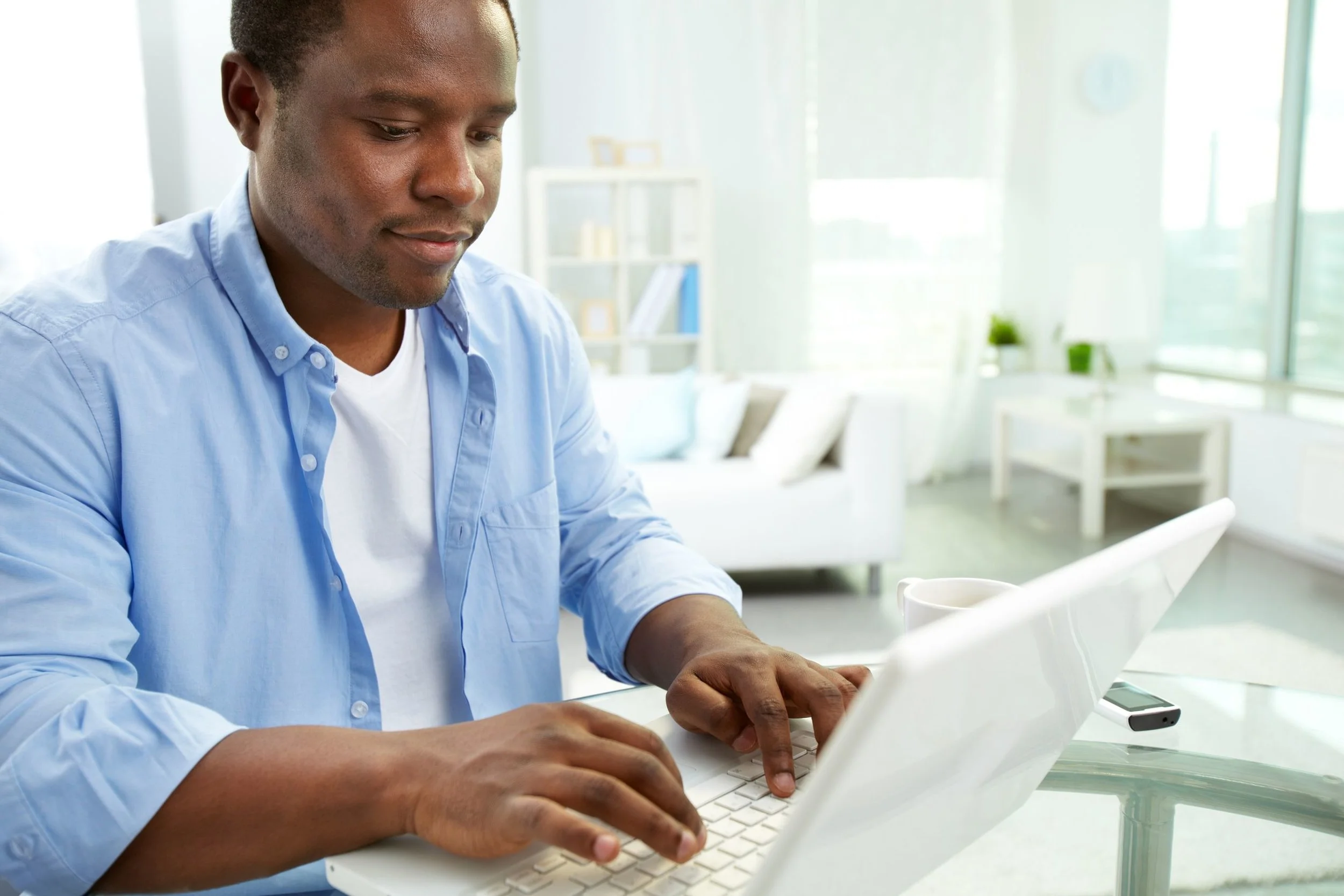 Man at laptop, working on his resume.