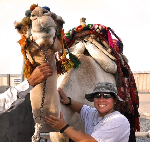 US Air Force Veteran Amber posing with a camel.
