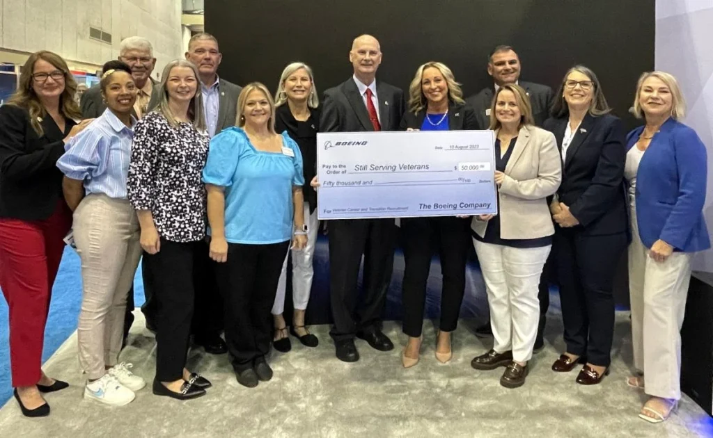 Boeing team members present a check for Still Serving Veterans.