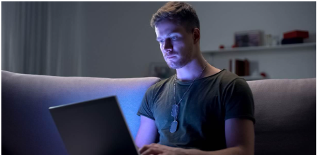 Veteran using his laptop to look for work.