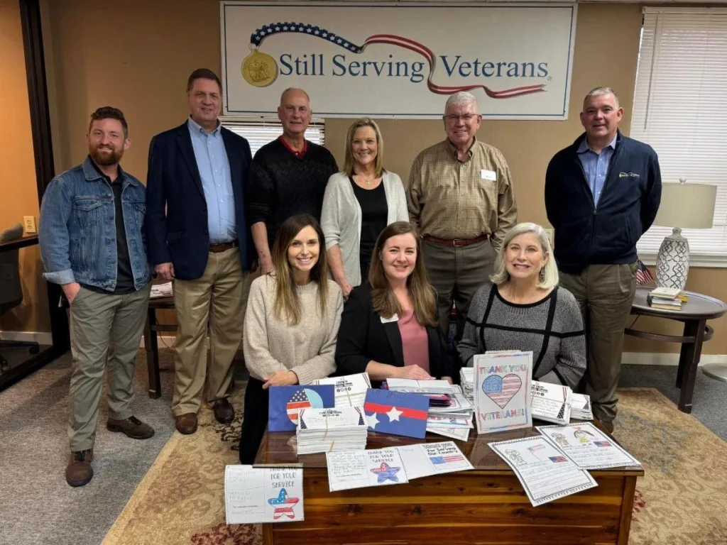 The Still Serving Veterans team with the thank-you cards and pictures from students all over North Alabama.