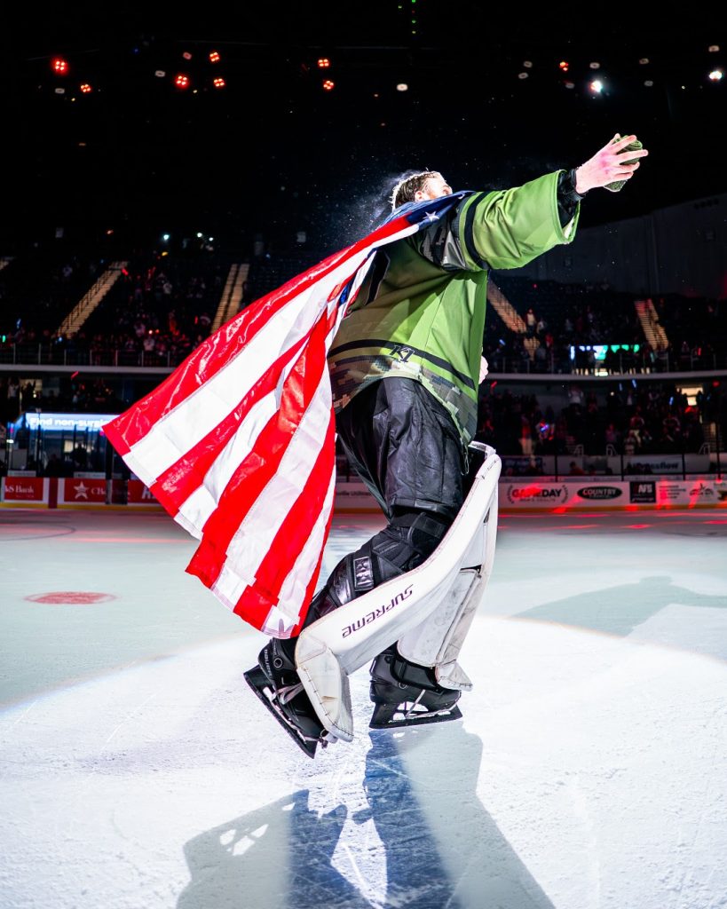 Goaltender holding an American flag during Huntsville Havoc Military Appreciation Night.