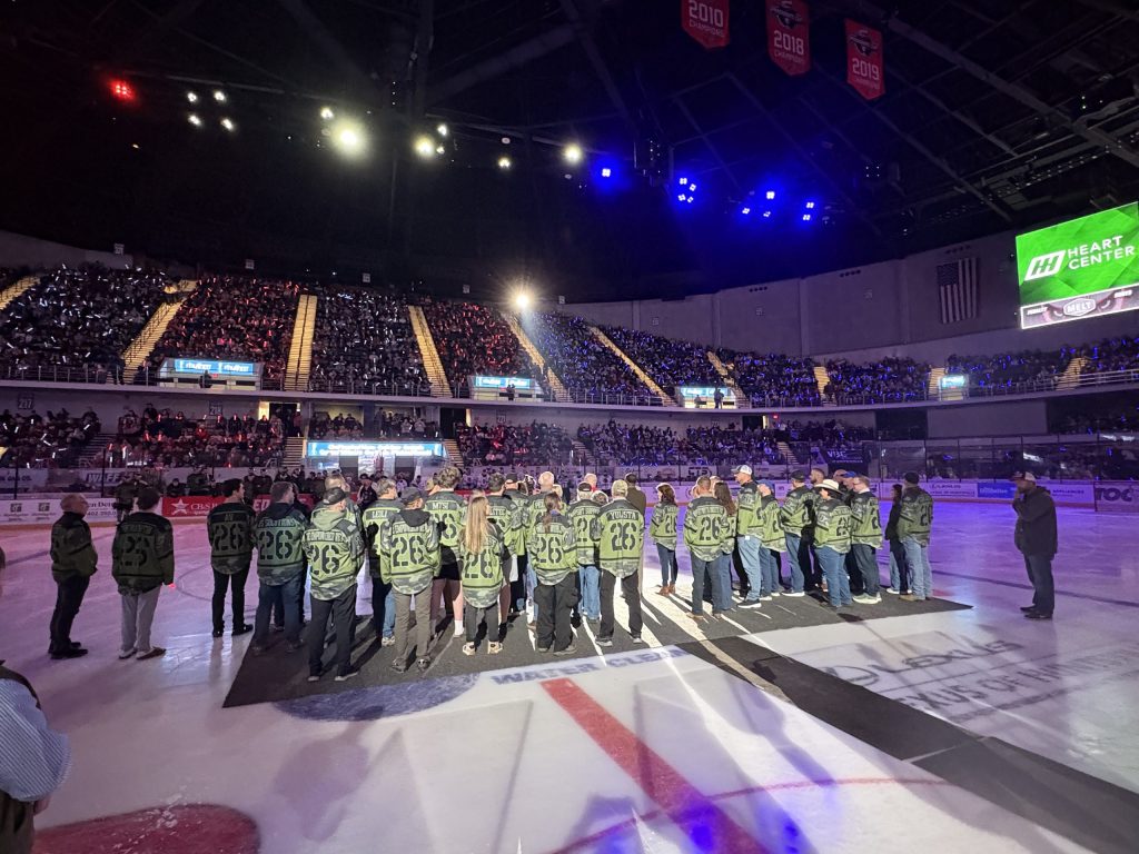 Veterans and supporters standing on the ice during Huntsville Havoc Military Appreciation Night.