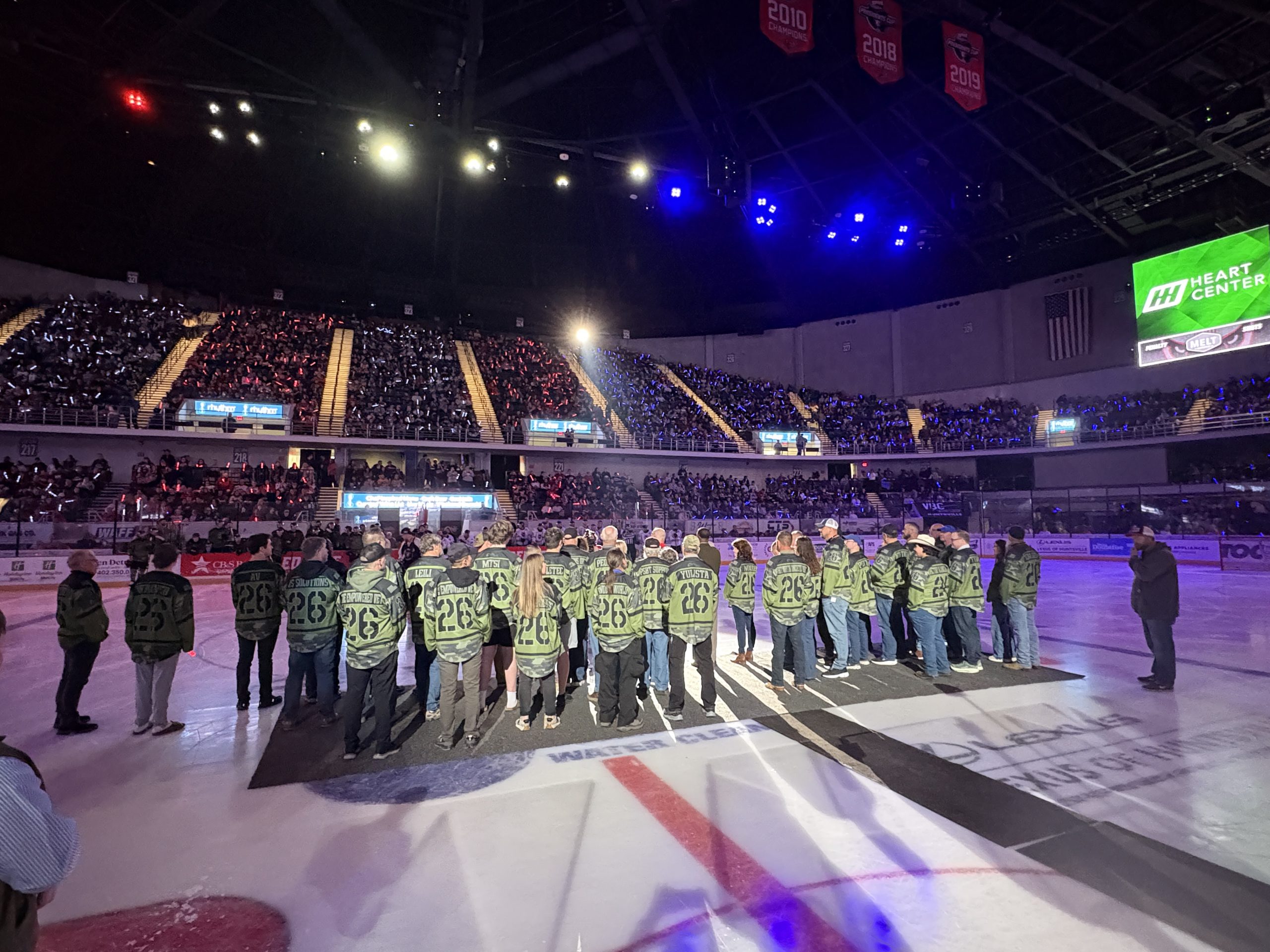 Veterans and supporters standing on the ice during Huntsville Havoc Military Appreciation Night.