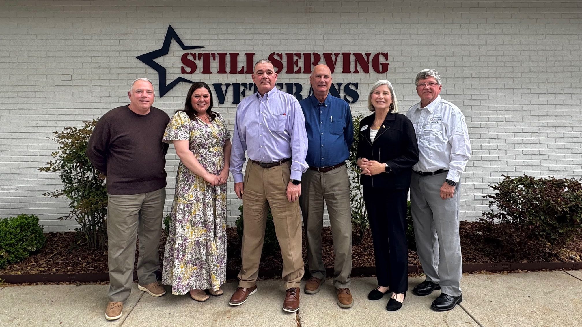 Still Serving Veterans leadership group with Alex Karagas and COL Larry Vannoy, standing outside the SSV office building.