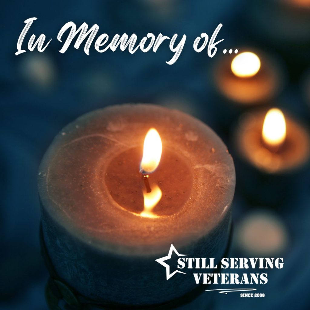 Memorial candle with the words In Memory Of, honoring a veteran.