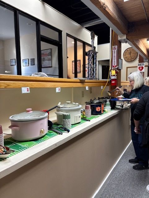 Debbie Joyner serving soup during the Still Serving Veterans Souper Bowl staff competition.