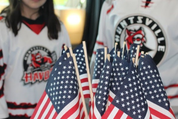 American flags displayed at a Huntsville Havoc Military Appreciation event supporting veterans.
